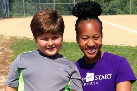 A camp counselor with a camper at a Jump Start Sports program